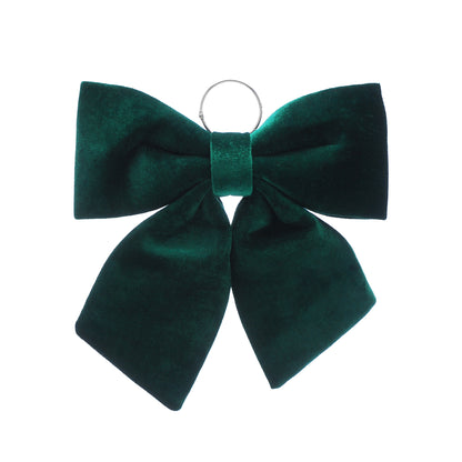 A dark green velvet bow with a silver metal hanging ring at the center, shown against a plain white background.