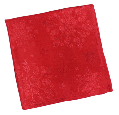 A square red fabric napkin featuring a subtle tonal jacquard snowflake pattern, shown on a plain white background.