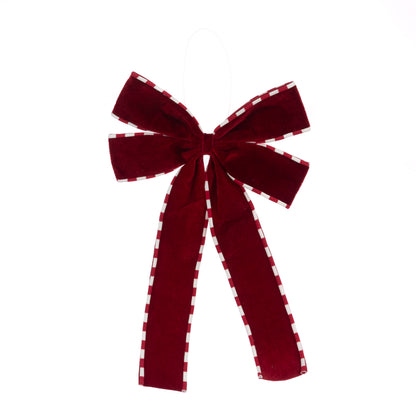 A large burgundy velvet bow with white checkered trim, hanging against a plain white background.