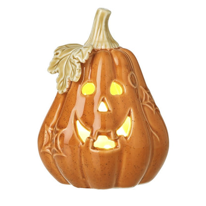 A ceramic jack-o'-lantern pumpkin decoration with a warm orange-brown speckled glaze, carved facial features, spiderweb details, and a light beige stem and leaf, shown against a plain white background.