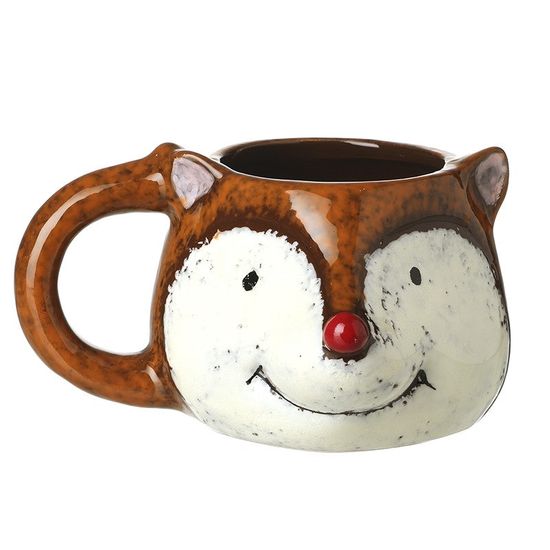 A ceramic mug shaped like a smiling fox face, with a brown glossy head and handle, a white face, small black eyes and mouth details, and a red nose, shown on a plain white background.