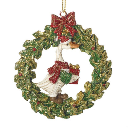 Christmas ornament with a goose in a wreath, wearing a red hat and holding a gift.