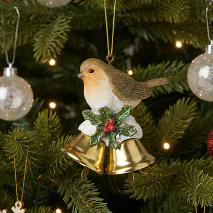 Christmas ornament of a robin with gold bells and holly on a decorated tree.