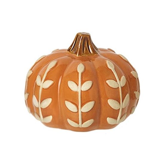 An orange ceramic pumpkin figurine decorated with raised cream-colored leaf patterns and a brown stem, set against a plain white background.