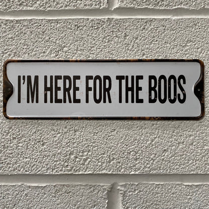 Halloween sign, that reads I'm here for the boos, placed on a white brick wall
