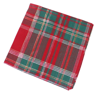 A folded tartan plaid fabric napkin featuring a classic red, green, and gold plaid pattern with thin white and yellow stripes, shown on a plain white background.
