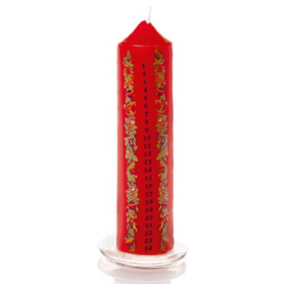 Red candle with green leaf pattern on a white background