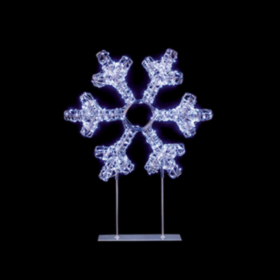 Decorative snowflake lights on stands against a black background