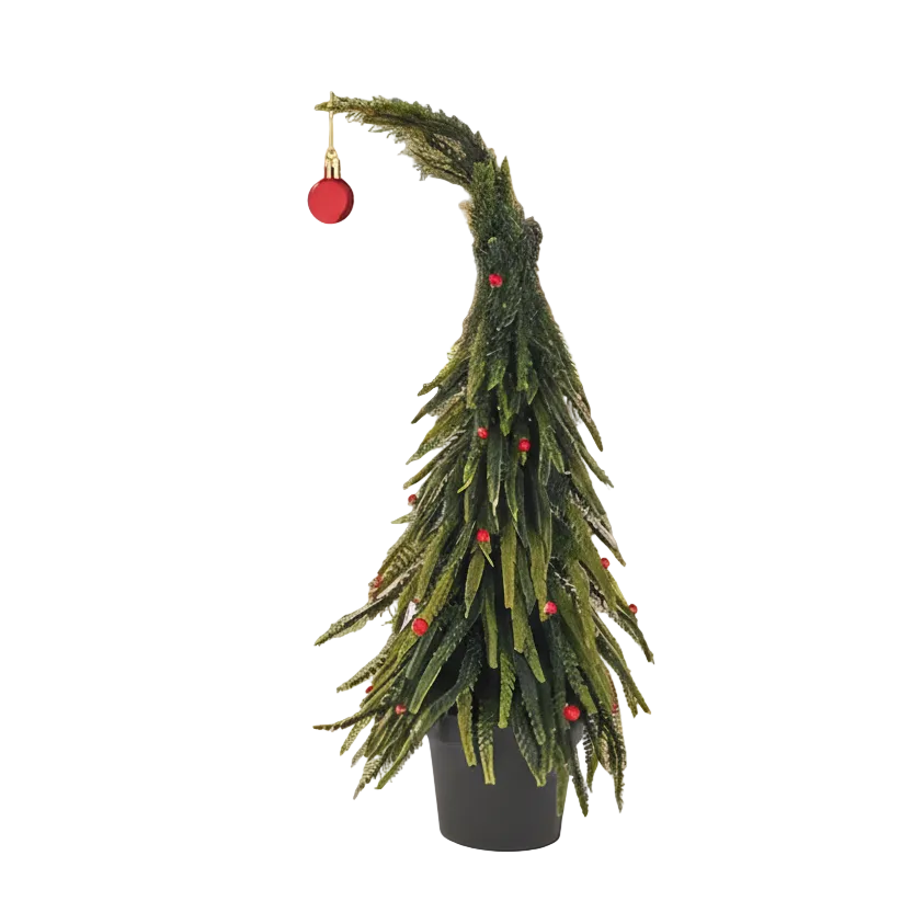 Small potted Christmas tree with red ornaments in a kitchen setting with blurred lights in the background.
