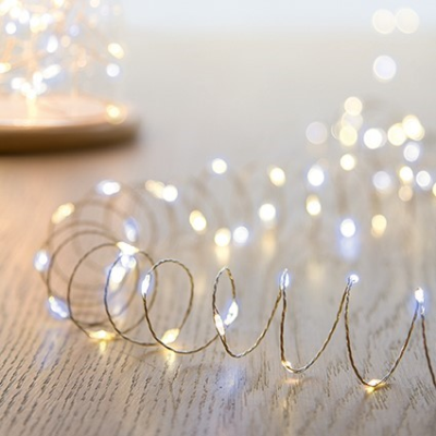 String of small lights on a wooden surface