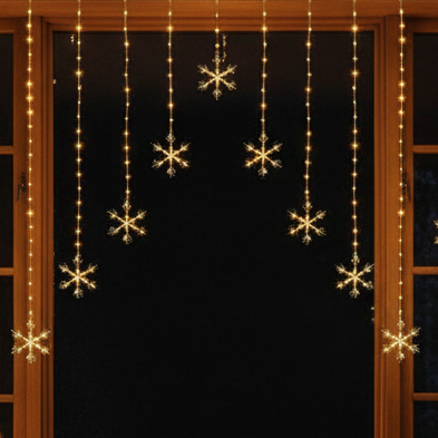 Snowflake-shaped lights hanging from a curtain against a dark background