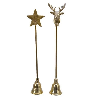 A pair of gold-colored candle snuffers, one with a star-shaped head and the other with a stag's head, both mounted on bell-like bases.