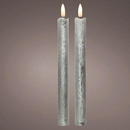 Two silver colored LED wick candles with a waved top, designed to resemble a real wax candle, placed on a textured background.