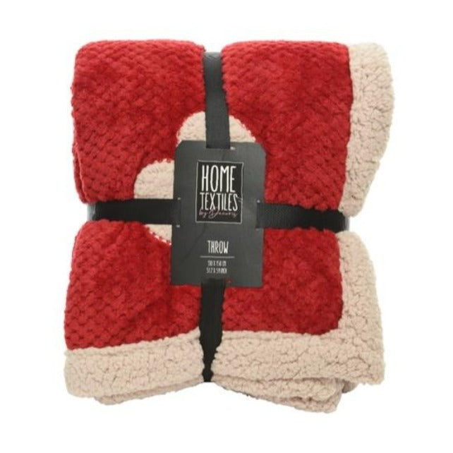 A red and cream colored throw blanket with heart embroidery, displayed with a black label that reads 'HOME TEXTILES'.