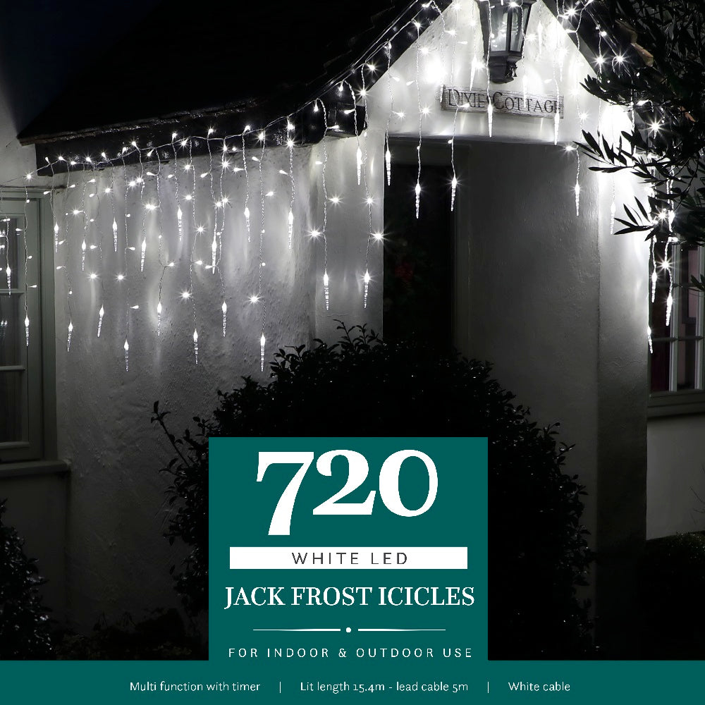 A house at night decorated with white LED jack frost icicle lights hanging from the gutters, with the brand name '720 White LED Jack Frost Icicles' displayed.