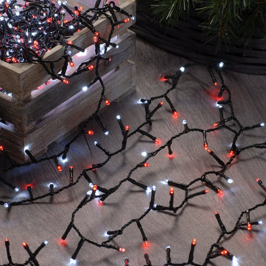 A string of red and white Christmas lights displayed on a wooden surface, creating a festive and vintage-like appearance.