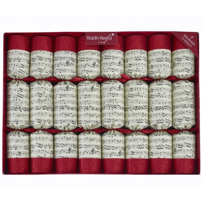 A set of eight musical Christmas crackers with gold and red design featuring musical notes, each containing a different colored metal handbell and numbered badge.