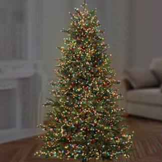 A decorated Christmas tree with multicolored LED lights in a room with a cozy interior.